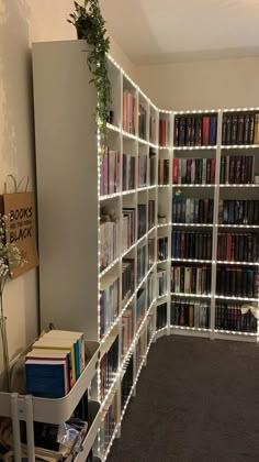 a bookshelf filled with lots of books next to a wall full of books