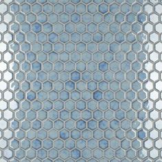 a blue and white tiled wall with hexagonal tiles in the center, as well as an abstract pattern