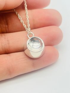 This is the perfect gift and a unique way to carry your loved ones close to your heart. ❤️FREE Personalization: message can be engraved on the back of the pendant; 18 characters maximum. ❤️Size: 1/2" diameter.  ❤️Material:  genuine 925 sterling silver ❤️Included in the package:18" matching silver chain,gift box, filling funnel kit; ❤️ Care Instructions: Though the materials used is made of sterling silver, I recommend you to not sleep, swim, or spray chemicals (i.e. perfumes, lotions, or body spray) on to the necklace to preserve its longevity. Please follow these tips to preserve the longevity of the necklace. To clean, it is best to use a soft microfiber cloth to clean the jewelry from smudges. Silver Round Pendant For Memorial, Elegant Nickel-free Charm Necklaces For Keepsake, Silver Memorial Locket Necklace Hallmarked, Silver Nickel-free Necklace For Memorial, Nickel-free Oval Pendant For Memorial, Ashes Necklace, Urn Jewelry, Memorial Jewelry, Body Spray