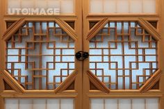 two wooden doors with decorative designs on them