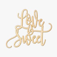 the word love is sweet spelled in cursive wood cutout on a white background