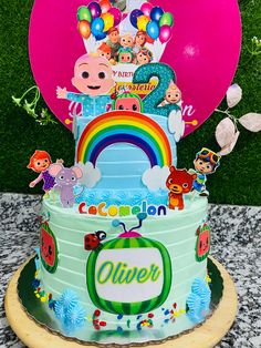 a birthday cake decorated with cartoon characters and balloons