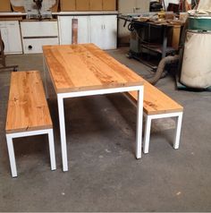 two wooden benches sitting next to each other on top of a cement floor in a garage