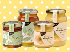 four jars of honey with labels on them