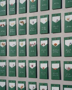 a wall covered in lots of green and white cards