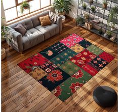 a living room filled with furniture and a rug on top of a hard wood floor