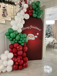 a christmas balloon arch with santa clause on it