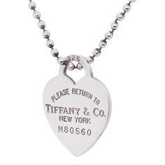 A fine silver heart tag necklace.  By Tiffany & Co.  In sterling silver.  With a heart shaped pendant reads "Please Return to Tiffany & Co. / New York / M80560" suspended on a dog tag chain.  Simply a wonderful piece from the classic Return to Tiffany line!  Date: Late 20th or Early 21st Century  Overall Condition: It is in overall good, as-pictured, used estate condition.   Condition Details: There is some light edge wear, some fine and light surface scratches, and other signs of light wear con Tiffany And Co Heart Tag Necklace, Tiffany Key, Key Charm Necklace, Return To Tiffany, Heart Shaped Pendant, Heart Tag, Tiffany And Co, Heart Shape Pendant, Dog Tag