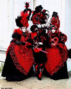 three women dressed in red and black costumes