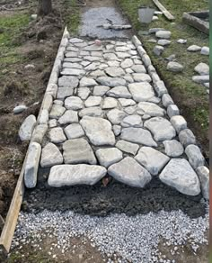 a stone path in the middle of a field