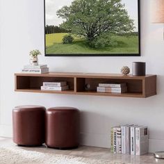 a living room with two brown stools and a wall mounted art piece on the wall