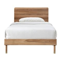 a bed with wooden headboard and white sheets