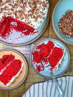 three plates with red velvet cake and pecans on the top one has a slice missing