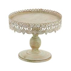 an ornately decorated cake stand on a white background