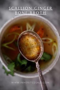 a close up of a spoon with soup in it