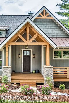 the front view of a house with stone and wood trimmings on the porch