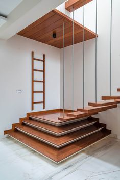 an empty room with wooden stairs and white walls