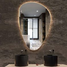 a bathroom with two sinks and a mirror on the wall