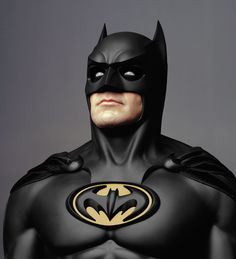 a man in a batman costume with his eyes closed and an angry look on his face