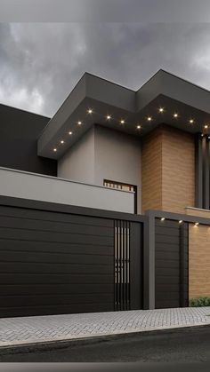 a modern house with two garages on the street