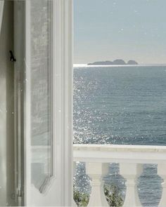 an open window looking out at the ocean