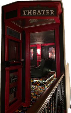 a red phone booth sitting next to a stair case