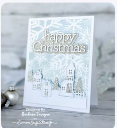 a christmas card with the words happy christmas written in silver on it and snowflakes