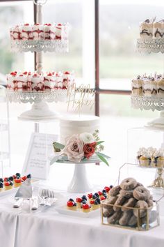 a table topped with lots of cakes and cupcakes