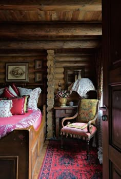 a bedroom with a bed, chair and rug in it's corner area next to a doorway