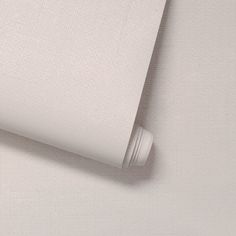 a close up view of a white sheet on a bed with the sheets pulled back