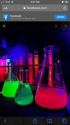 a group of flasks filled with colored liquid