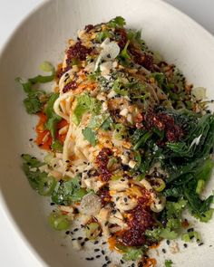 a white bowl filled with pasta and vegetables