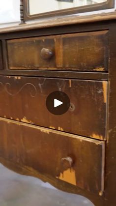 an old wooden dresser with a mirror on it's top and the bottom drawer missing