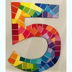 the number five is made out of colored paper