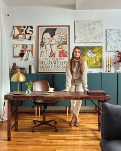 a woman is sitting at a desk in her living room