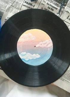 a record sitting on top of a table next to a pair of scissors and paper