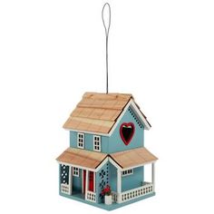 a blue birdhouse with a red heart on the roof and two stories below it