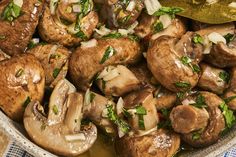 a bowl filled with mushrooms and onions next to a spoon