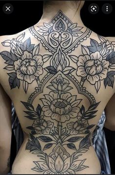 the back of a woman's body with flowers on it