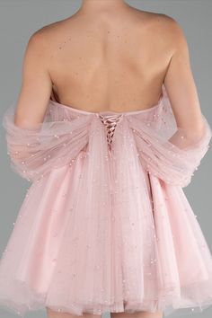 the back of a woman wearing a pink dress