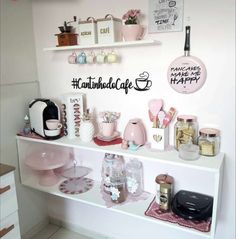 a white shelf filled with lots of items on top of a kitchen counter next to a wall