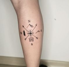 a person with a compass tattoo on their leg