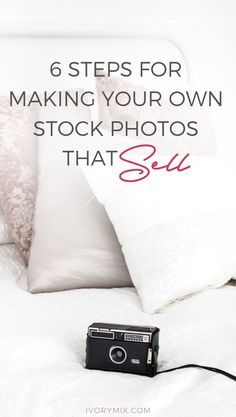 a camera sitting on top of a bed next to pillows and pillow cases with text overlay