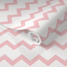 a pink and white zigzag wallpaper with a circular hole in the middle