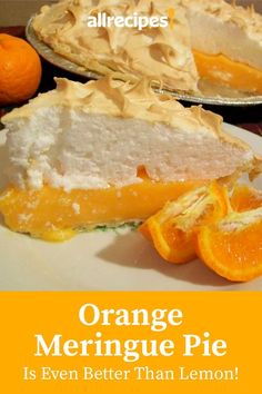 an orange meringue pie on a white plate next to some sliced oranges