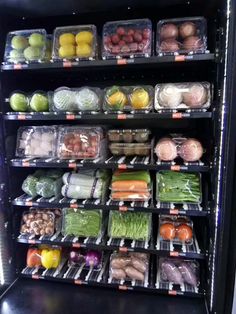 a vending machine filled with lots of different types of fruits and vegetables in plastic containers