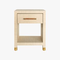 the side table is made out of wood and has a drawer on one end with a gold handle