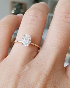 a woman's hand with a diamond ring on it