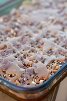 a casserole dish filled with lots of toppings on top of a wooden table