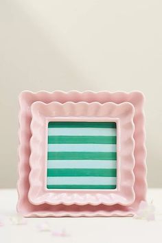 a pink and green striped square shaped plate